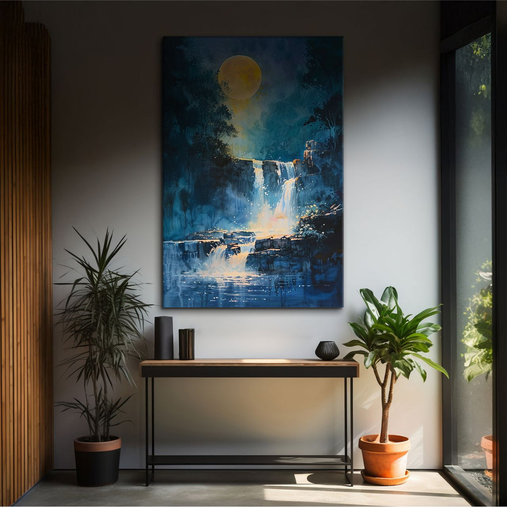 Framed artwork of a waterfall scene with a moon above, displayed on a wall in a room with plants and a console table.